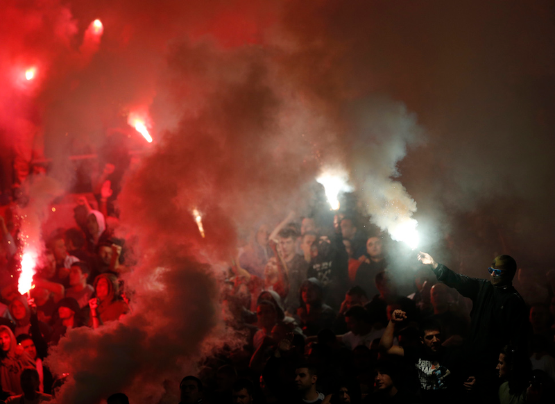 Illustration for article titled Smoke, Flares, Riot Police In Belgrade Derby Make For Haunting Photos